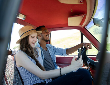 Young couple driving in pickup truck