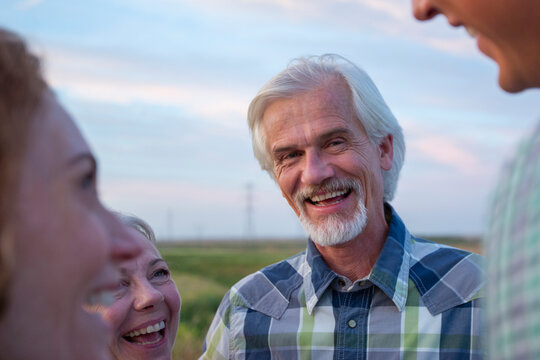 Daughter Talking With Older Parents Outdoors