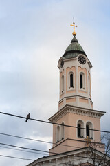 Fototapeta na wymiar Close up on Church clocktower steeple of the serbian orthodox church of Crkva svetog duha, church of the holy spirit, in Obrenovac, Serbia with its iconic clock indicating the time. ...
