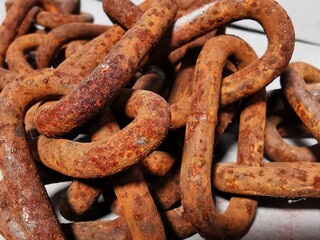 Close up view weathered old and rusty chain links.