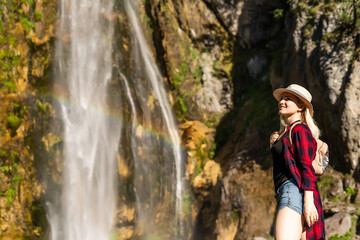 Naklejka na ściany i meble Theth, Albania, Europe. Tourists visiting the beautiful Albanian mountain waterfall