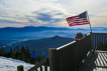 American flag waiving at the ski patrol house on the beautiful winter day at the Stowe Mountain Ski...