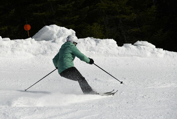 Ski, skier on ski run - woman skiing downhill, winter sport.