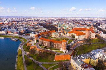 View from drone of medieval Castle complex on Wawel Hill on background of Krakow cityscape in spring day, Poland
