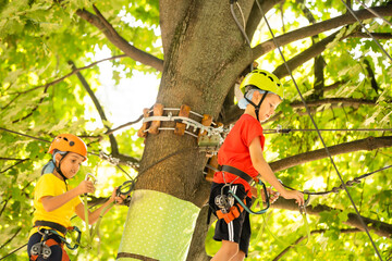 Cute children. Boy and girl climbing in a rope playground structure at adventure park