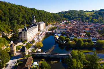 Scenic drone view of Brantome en Perigord on Dronne river with former Benedictine abbey on sunny...