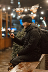 man with the phone. night city. winter. shopping, video communication.