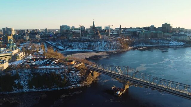 Aerial view of the Parliament of Canda with Alexandra Bridge and the National Gallery in the foreground in winter at sunset