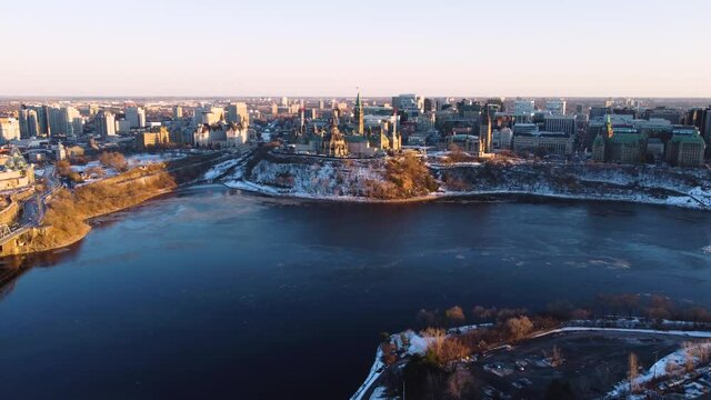 Aerial view of Parliament Hill in Ottawa Canada in early winter at sunset with the icy Ottawa river