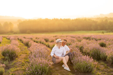 Naklejka na ściany i meble Beautiful couple on the lavender field