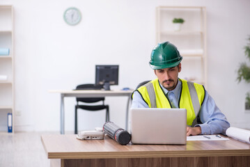 Young male architect working in the office