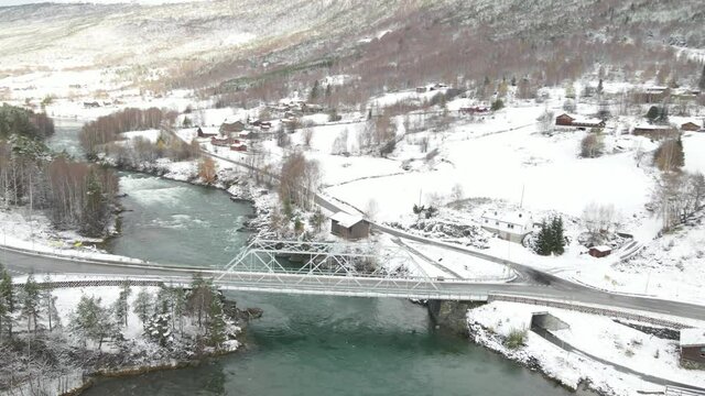 Road Bridge Over Otta River At Winter. Donfoss River View In Norway. aerial orbit