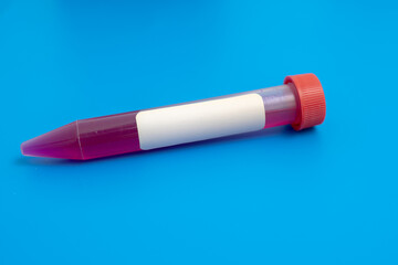 Test tube with empty label  to biological sample for medical laboratory research on blue background