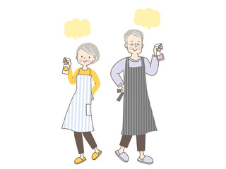 家の中を除菌する笑顔のシニア夫婦