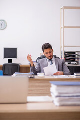 Young male employee working in the office