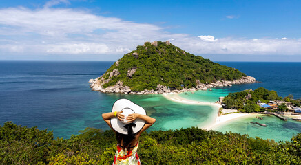 Freedom lifestyle as a Happy Woman  wearing white hat Enjoying with the Nature in seashore background