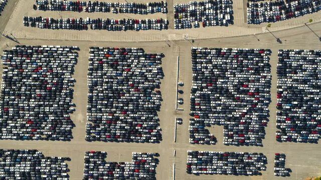 Aerial Panning High Above A Parking Lot Of Many Cars Crowded Into Tandem Lanes - Los Angeles, California