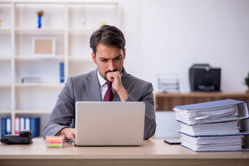 Fototapeta premium Young male employee working in the office