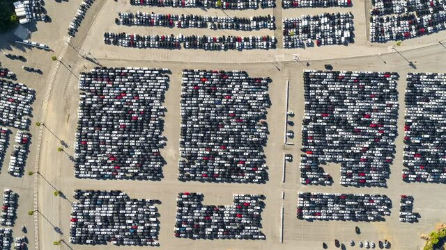 Aerial Short Pan High Above A Parking Lot Full Of Many Cars Crowded Into Tandem Lanes - Los Angeles, California
