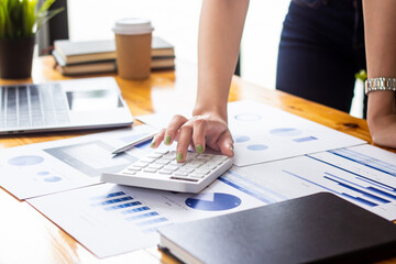 Businesswoman analyzing company sales data for the past year, woman looking at financial documents on desk, accountant checking company numbers, concept of modern businessman.