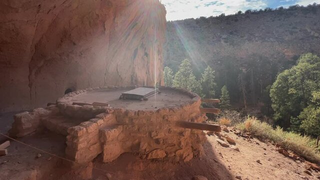 Ancient indigenous Kiva built in rock cliff shadow in New Mexico