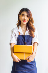 Small business owner looking at company's past online sales, cropped image of woman holding her own box for delivery at online sales office, merchandising concept and modern businessman.