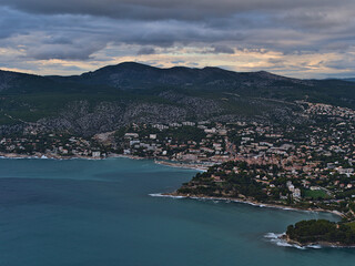 Fototapeta na wymiar Aerial view of the French Riviera with small town Cassis at the mediterranean coast on cloudy day in autumn viewed from the top of cliffs Falaises.