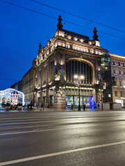 Fototapeta premium Eliseevsky store and Malaya Sadovaya street in St. Petersburg, decorated with garlands for Christmas and New Year.