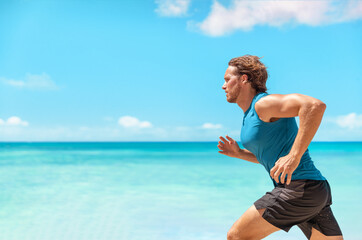 Athlete man runner training cardio running fast sprinting during beach workout running profile...
