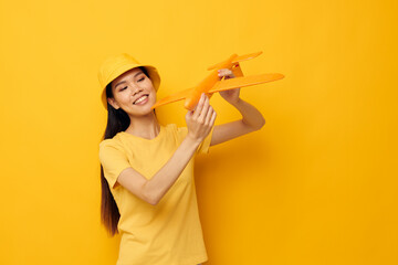 woman in a hat with an airplane in his hands model toy isolated background unaltered