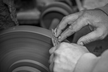 Isolated close up of chef knife sharpening, honing and stropping process by  a skilled craftsman. Vintage old school craftsman at work in grange shop showing true professional skills.