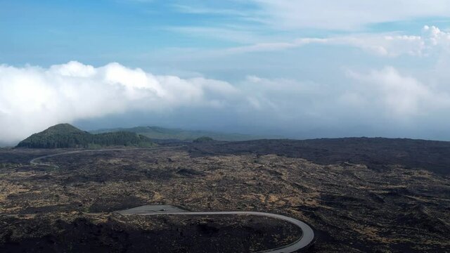 car drive past on a curved road on the vulcano etna on the island sicilia in italy