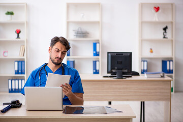 Young male doctor working in the clinic