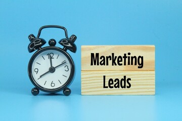 alarm clocks and colored boards with the words marketing leads