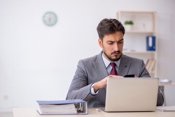 Young male employee working in the office