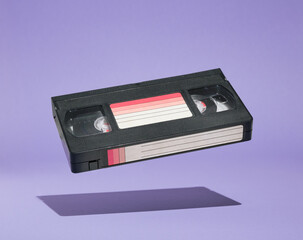 VHS video cassette hovers above the surface. Retro dreamy design. Fun with friends and positive...