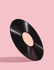 Vinyl record on pink background. Music dreamy design. Vintage creative composition.