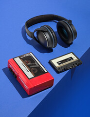 Retro composition with cassette player, audio cassette and headphones. Aesthetics of music, 80s and...