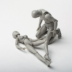 The male figurine bent over the recumbent body of the female figurine.