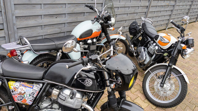 triumph bonneville vintage and royal enfield GT interceptor neo retro motorcycles ancient parked outdoor