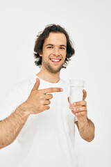 Cheerful man in a white T-shirt glass of water Lifestyle unaltered