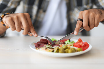 Male hands cutting fresh vegetables, closeup photo