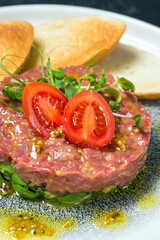 Fresh Tartare dish with tomatoes on a plate.