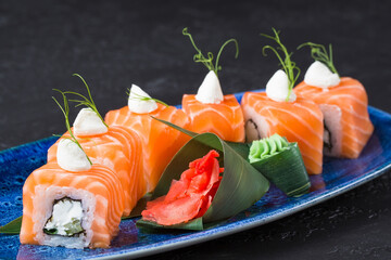 Fresh sushi dish on a blue plate.