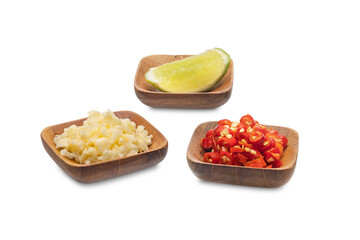 Chili, minced garlic and sliced lemon in a small wooden bowl isolated on white background. Clipping path.