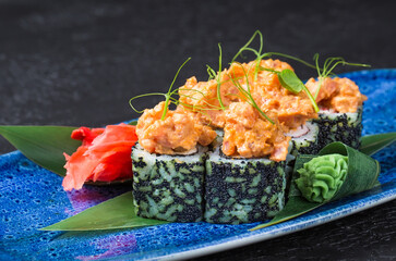 Fresh sushi dish on a blue plate.