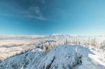 Climbing Piatra Mică Peak may be difficult, but the view from the top is beautiful. Piatra Craiului National Park from Romania. People hiking in winter mountains for winter sport snow mountain hills