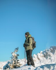 Fototapeta na wymiar People hiking in beautiful winter mountains for winter sport activity snow mountain hills. Going for hikes in the winter for winter sports like winter hiking and cross-country skiing is very rewarding