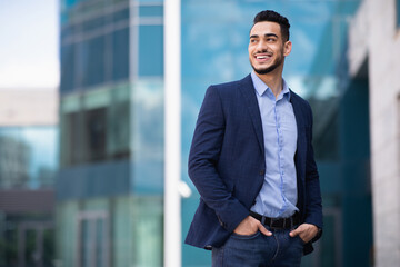 Young arab man standing by business center