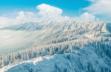 Obraz premium Climbing Piatra Mică Peak may be difficult, but the view from the top is beautiful. PPiatra Craiului National Park from Romania. People hiking in winter mountains for winter sport snow mountain hills